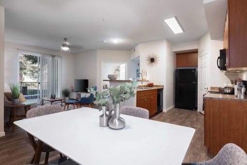 a kitchen and dining room with a white table