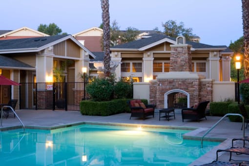 a swimming pool in front of a house with a pool