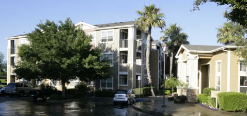 an apartment building with cars parked in front of it