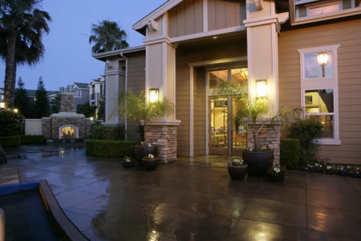 a patio in front of a house with a fireplace