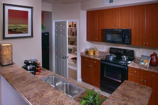 a kitchen with granite counter tops and black appliances