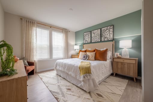 a bedroom with a bed and two windows