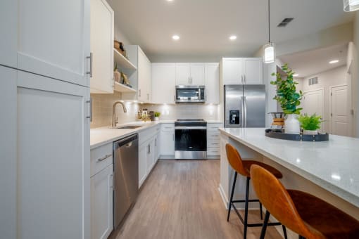 a kitchen with white cabinets and a white counter top