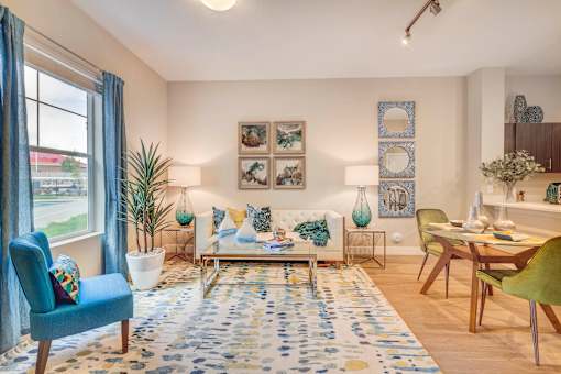 a living room and dining room with a table and chairs