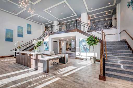 the lobby of a building with stairs and a landing