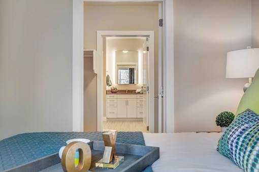 a bedroom with a bed and a view of a bathroom