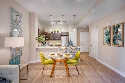 a dining room and kitchen with a table and chairs