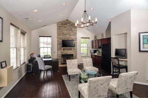 a living room and kitchen with a table and chairs