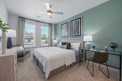 a bedroom with green walls and a white bed