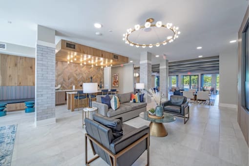 a living room with couches and chairs and a chandelier