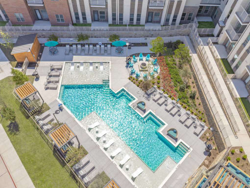 an aerial view of a swimming pool in an apartment building