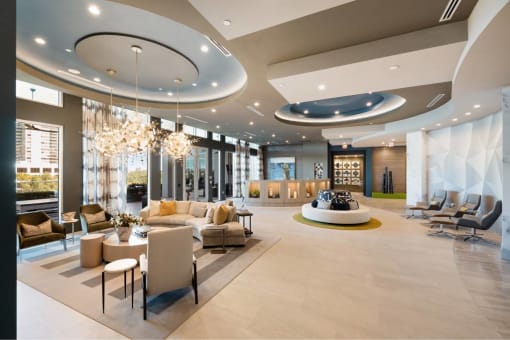 a large lobby with couches and chairs and a table