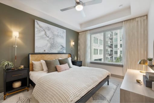 a bedroom with a bed and a ceiling fan