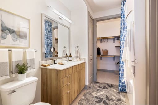 a bathroom with a toilet and a sink and a shower