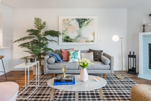 a living room with a gray couch and a coffee table