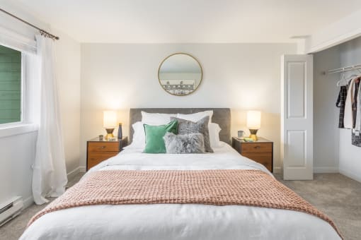 a bedroom with a bed and a closet and a window