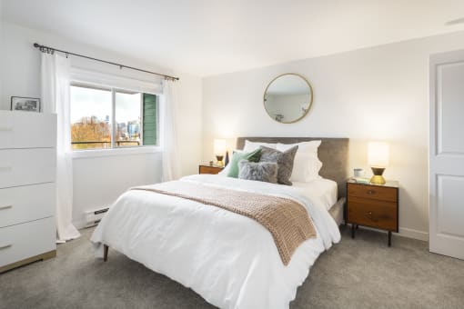a bedroom with a bed and a window