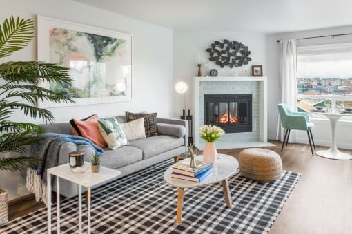 a living room with a couch and a fireplace   and a table