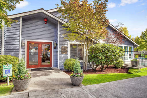 the front of a blue house with a red door
