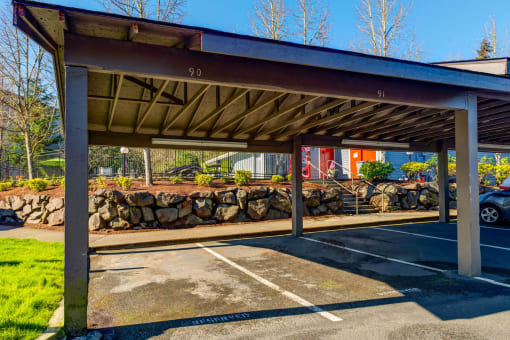 a parking garage with a roof over a parking lot