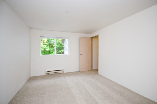 a white room with a window and a door