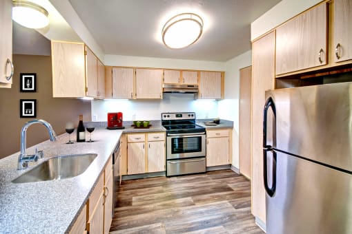 a kitchen with stainless steel appliances and wooden cabinets