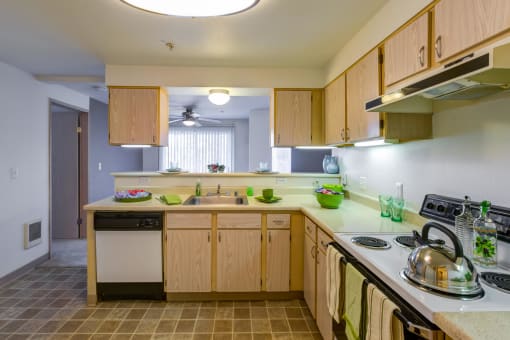 a kitchen with wooden cabinets and a stove and sink