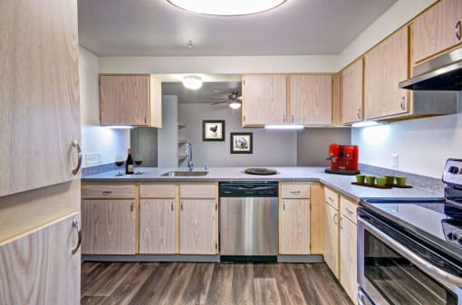 spacious kitchen with wood cabinets and stainless steel appliances at the preserve at great neck apartments