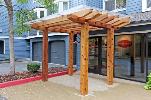 a patio with awning in front of a building