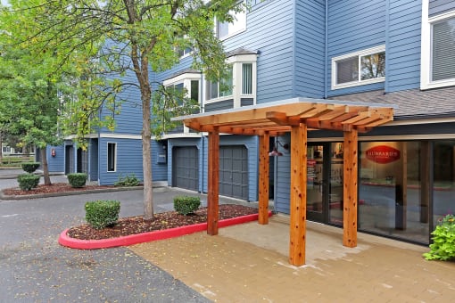 a wood archway in front of a blue building