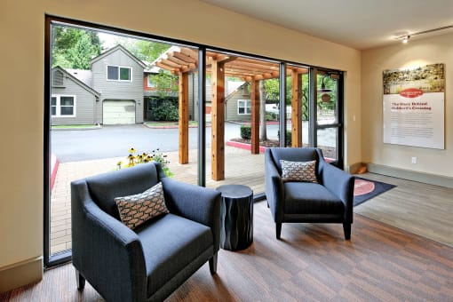 a living room with two chairs and a table