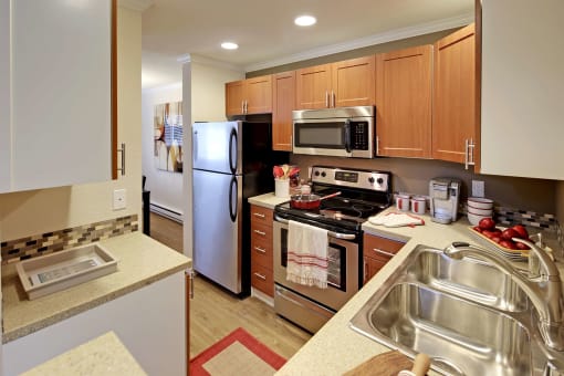 a kitchen with stainless steel appliances and wooden cabinets