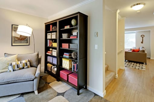 a living room with a couch and a bookcase
