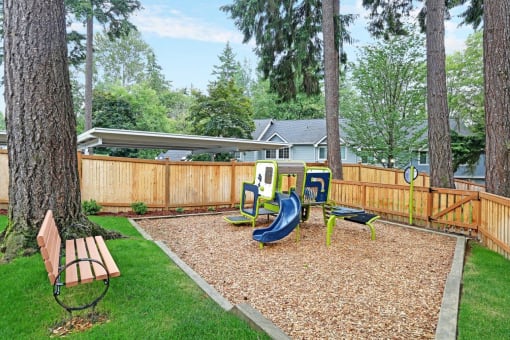 the backyard has a playground with slides and a swing set