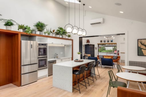 a kitchen with a large island and a table with chairs