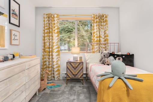 a bedroom with a bed and a window with curtains