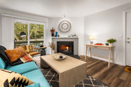 a living room with a fireplace and a blue couch