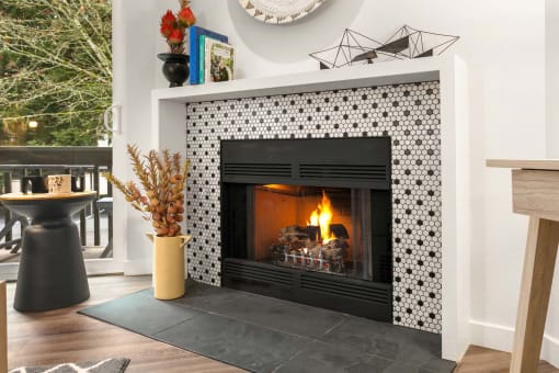 the fireplace in the living room is decorated with black and white tiles