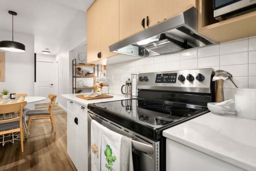 a kitchen with a stove top oven and a sink
