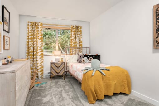 a bedroom with a bed and a window with a yellow curtain
