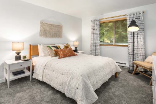 a bedroom with a bed and a window