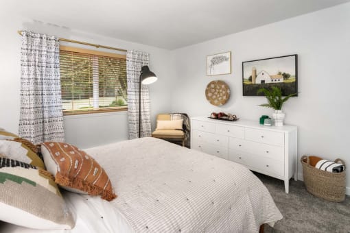 a bedroom with a bed and a dresser