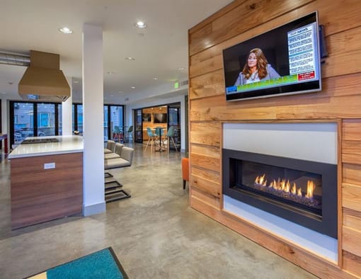 a living room with a fireplace and a tv