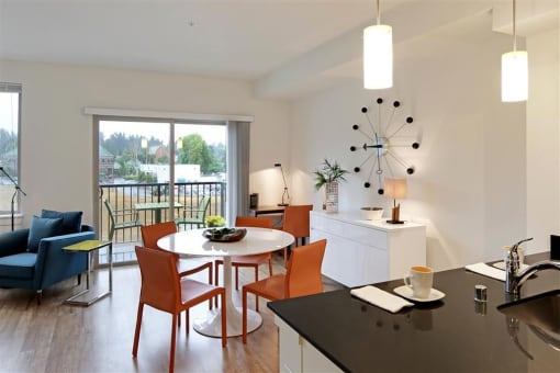 a living room and dining room with a table and chairs