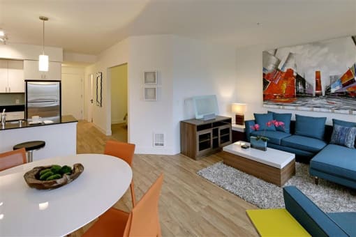 a living room and dining room with furniture and a table