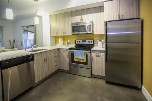 a kitchen with stainless steel appliances and wooden cabinets