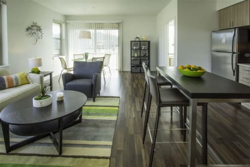 a living room and dining room with a table and chairs