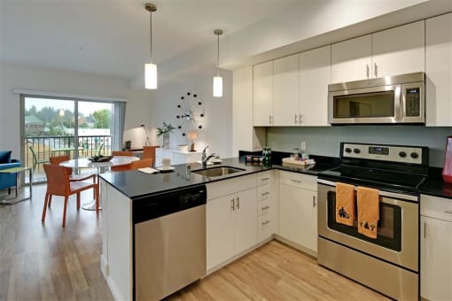 a kitchen with a stove and a sink and a microwave