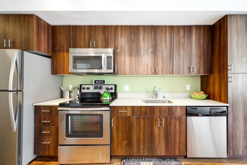 a kitchen with stainless steel appliances and wooden cabinets