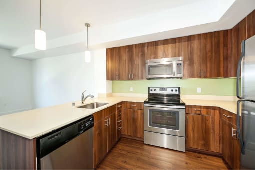 a kitchen with stainless steel appliances and wooden cabinets